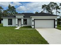 Single-Gathering home with attached garage and manicured lawn at 2491 Sw 170Th Loop, Ocala, FL 34473