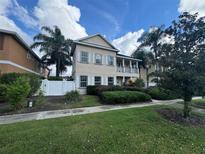 Two-story house with landscaping at 7706 Excitement Dr, Reunion, FL 34747