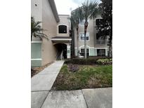 Exterior view of a condo building with palm trees at 4817 Cypress Woods Dr # 5107, Orlando, FL 32811