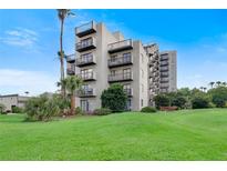 Modern building with balconies and lush lawn at 6165 Carrier Dr # 1210, Orlando, FL 32819