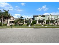 Row of townhouses with front porches and street parking at 1563 Reflection Cv, Saint Cloud, FL 34771