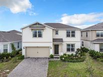 Two story house with a two car garage and landscaped yard at 5616 Arborvista Dr, St Cloud, FL 34771