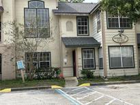 Exterior view of building with entrance and parking at 4113 Enchanted Oaks Cir # 1216, Kissimmee, FL 34741