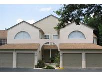 Inviting exterior of a two-story condo building with attached garages at 6147 Sunnyvale Dr, Orlando, FL 32822