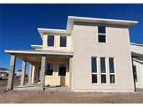 Two-story house with beige siding, covered porch, and large windows at 10257 Medawar St, Orlando, FL 32827