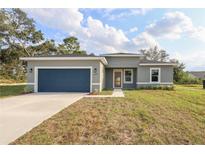 Newly constructed one-story home with a two-car garage and landscaped lawn at 4058 Sw 167Th St, Ocala, FL 34473
