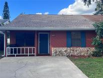 Front view of a ranch style home with teal door and stone accents at 437 Cottonwood Dr, Altamonte Springs, FL 32714