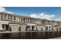 Modern townhouses with attached garages and landscaping at 5141 Quakers Pl, Saint Cloud, FL 34769