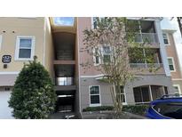 Three-story condo building with parking and trees at 3384 Corona Village Way # 108, Orlando, FL 32835
