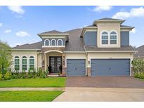 Two-story home with stone accents and three-car garage at 4485 Renly Ln, Clermont, FL 34711