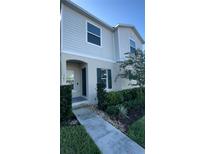 Two-story house with light gray siding, green shutters, and a walkway at 301 Primrose Dr, Davenport, FL 33837