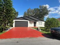 Newly painted house with a red driveway at 641 Bayport Dr, Kissimmee, FL 34758