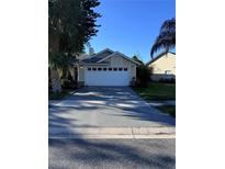 House exterior featuring a two-car garage at 2939 Falling Tree Cir, Orlando, FL 32837