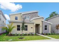 Two-story home with modern design, stone accents, and palm trees at 4625 Target Blvd, Kissimmee, FL 34746