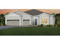 Two-story house with two car garage and landscaped yard at 1604 Evening Summit Cir, Minneola, FL 34715