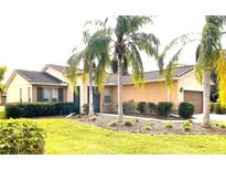 One-story house with palm trees, manicured lawn, and attached garage at 3070 Silver Fin Way, Kissimmee, FL 34746