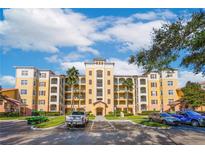 Three-story residential building with ample parking and lush landscaping at 8815 Worldquest Blvd # 103 In Building 3, Orlando, FL 32821