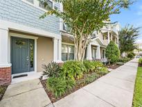 Attractive townhouse with gray siding and landscaping at 594 Piazza Pt, Oviedo, FL 32765