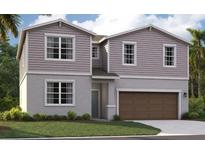 Two-story house with a brown garage door at 1242 Normandy Dr, Haines City, FL 33844