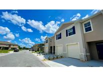 Modern townhome with attached garage and landscaped yard at 1089 Blue Jay Dr, Davenport, FL 33837