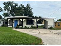 One-story house with blue door and arched entryway at 2149 Monte Carlo Trl, Orlando, FL 32805