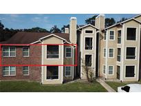 Brick and siding two-story condo exterior at 5600 Devonbriar Way # N202, Orlando, FL 32822