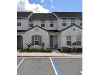Modern townhome with gray siding, two-story design, and landscaping at 314 Captiva Dr, Davenport, FL 33896