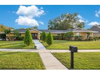 Single-story home with mature landscaping, walkway, and mailbox at 2506 Emerald Tree Ln, Apopka, FL 32712