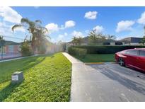 Community view showing lush landscaping and parking at 1048 Universal Rest Pl, Kissimmee, FL 34744