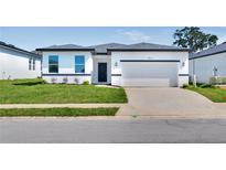 Modern one-story home with white exterior and two-car garage at 4475 Nw 1St Ter, Ocala, FL 34475