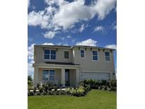 Two-story house with a landscaped lawn at 3722 Bluethread Way, Poinciana, FL 34759
