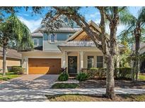 Two-story craftsman style home with large trees and landscaping at 11542 Brightstowe Way, Orlando, FL 32836