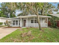 Charming house exterior with a covered porch and well-maintained lawn at 4221 Mizell St, Orlando, FL 32812