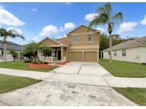 Two story house with a two car garage and landscaped yard at 10472 Eastpark Lake Dr, Orlando, FL 32832