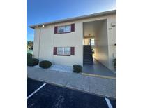 Exterior view of a condo building with stairs at 5505 Hernandes Dr # 238, Orlando, FL 32808