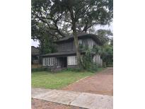 Two-story house exterior with brick driveway and large tree at 522 S Osceola Ave, Orlando, FL 32801