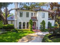 Two story home with lush landscaping and a circular driveway at 2228 Azalea Pl, Winter Park, FL 32789