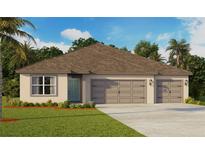 Tan house with three car garage and brown roof at 2542 Sage Valley Way, Winter Haven, FL 33884