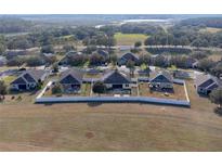 Community overview with houses and surrounding landscape at 176 Blackstone Creek Rd, Groveland, FL 34736