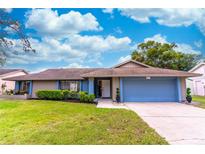 Ranch-style home with a two-car garage and well-manicured lawn at 832 Rill Dr, Altamonte Springs, FL 32714