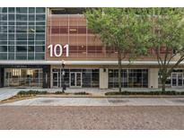 Modern building exterior with brick sidewalks and landscaping at 101 S Eola Dr # 812, Orlando, FL 32801