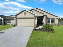 One-story home with attached garage and well-maintained landscaping at 4394 Sagefield Dr, Harmony, FL 34773