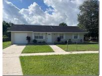 Ranch-style home with a double driveway and well-maintained lawn at 512 W Ella J Gilmore St, Apopka, FL 32703
