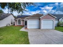 Two-car garage and pink exterior at 5418 S Bracken Ct, Winter Park, FL 32792