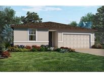 One-story home with attached garage, landscaping, and a spacious lawn at 3542 Rutland Ln, Haines City, FL 33844