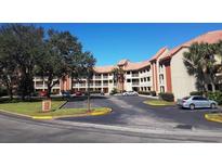 Two-story building with parking lot and landscaping at 6337 Parc Corniche Dr # 2106, Orlando, FL 32821