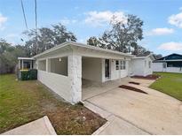 House exterior showcasing a covered entryway and landscaping at 908 Perkins St, Leesburg, FL 34748