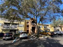 Apartment building exterior with parking and landscaping at 2302 Midtown Ter # 1228, Orlando, FL 32839