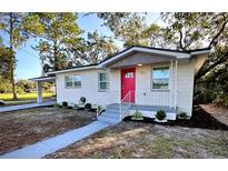 Newly remodeled home with pink door and landscaped yard at 709 N Lincoln Ave, Lakeland, FL 33815