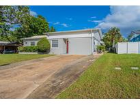 House exterior with a red door and a long driveway at 3121 Bon Air Dr, Orlando, FL 32818
